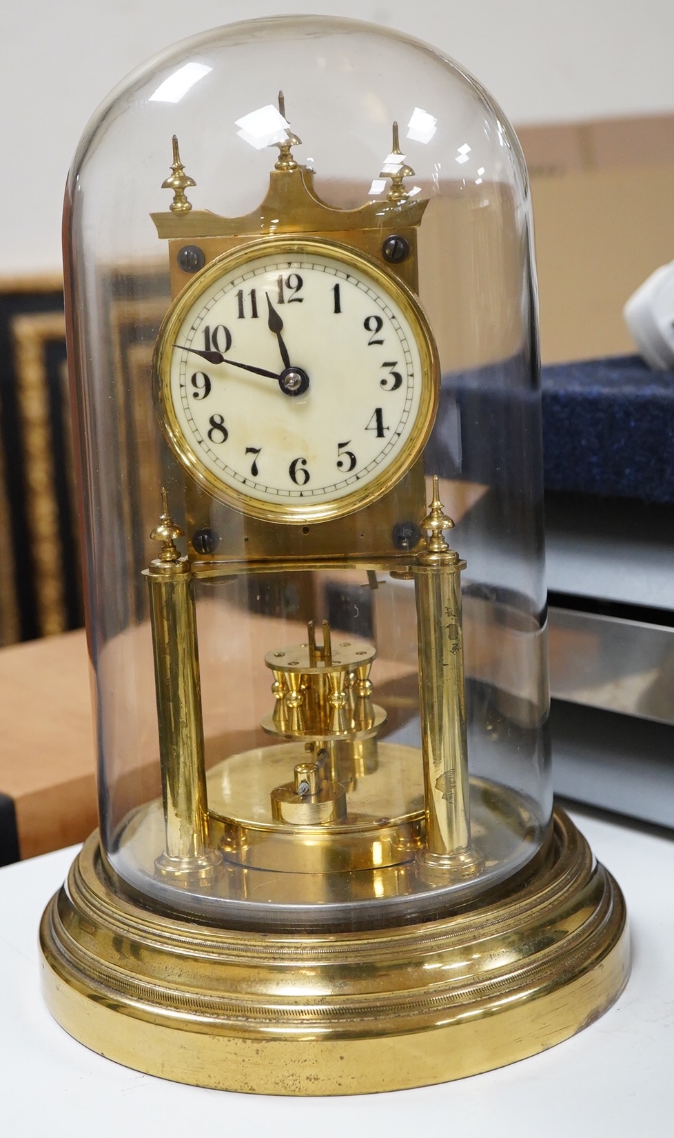 A late 19th century 400 day brass Anniversary clock, under glass dome, 29cm high